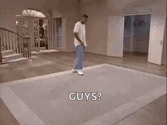A Man Is Dancing On A Rug In A Living Room While Holding A Tennis Racquet . GIF