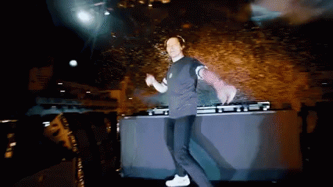 A Man Is Dancing On A Stage In Front Of A Mixer GIF