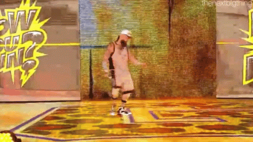 a man is dancing on a stage in front of a sign that says the next thing .
