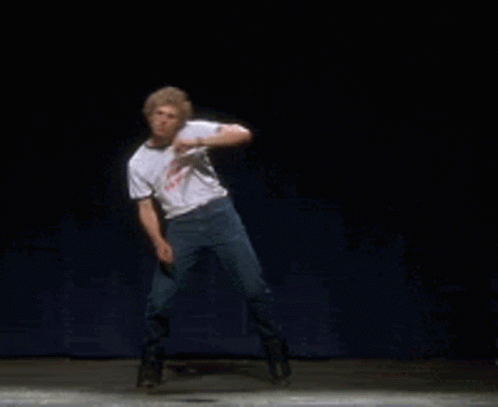 A Man Is Dancing On A Stage With A Shirt That Says ' I 'M A Loser ' On It GIF