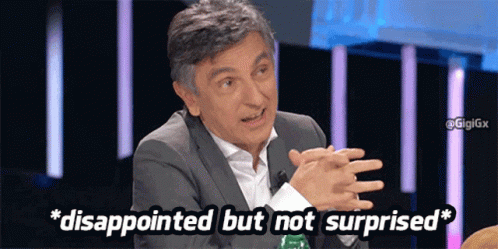A Man Is Disappointed But Not Surprised While Sitting At A Table With His Hands Folded GIF