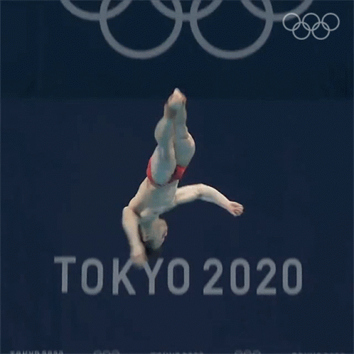 a man is diving into a pool in front of a tokyo 20 sign