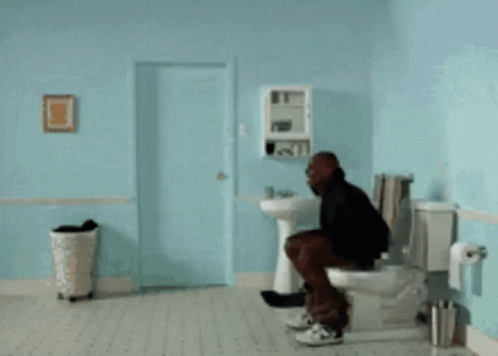 A Man Is Doing A Handstand In A Bathroom With A Sink And Toilet GIF
