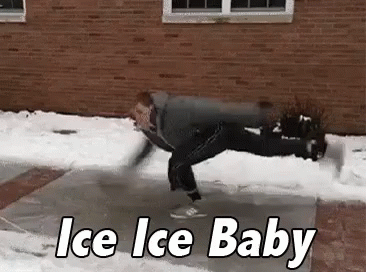 A Man Is Doing A Handstand On Ice In Front Of A Building . GIF