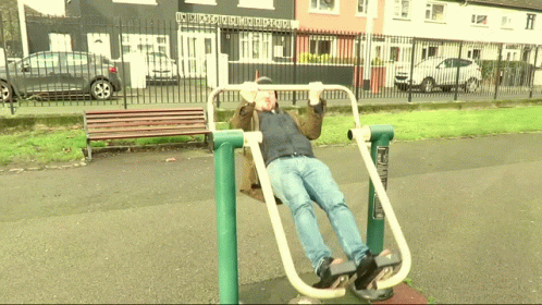 Man Exercising In Park Front Of Building GIF