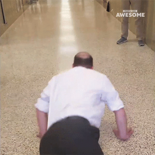 a man is doing push ups in a hallway with the words awesome on the bottom