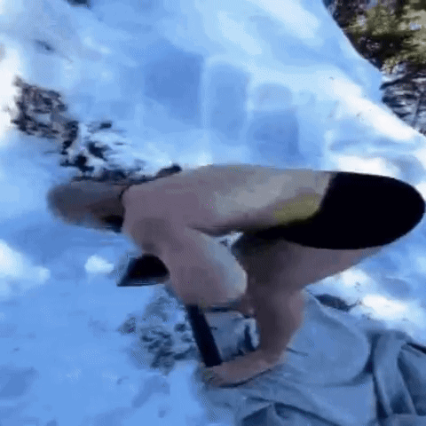 A Man Is Doing Push Ups In The Snow Without A Shirt On . GIF