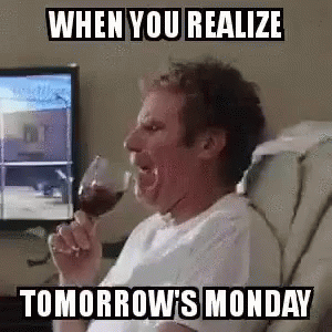 A Man Is Drinking A Glass Of Wine While Sitting In A Chair In Front Of A Computer Screen . GIF