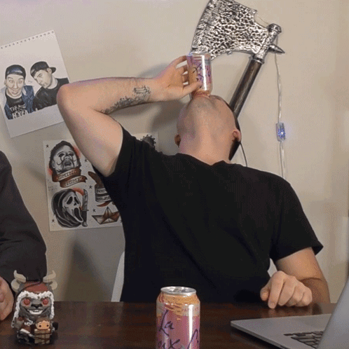 A Man Is Drinking From A Can That Says La Rock GIF