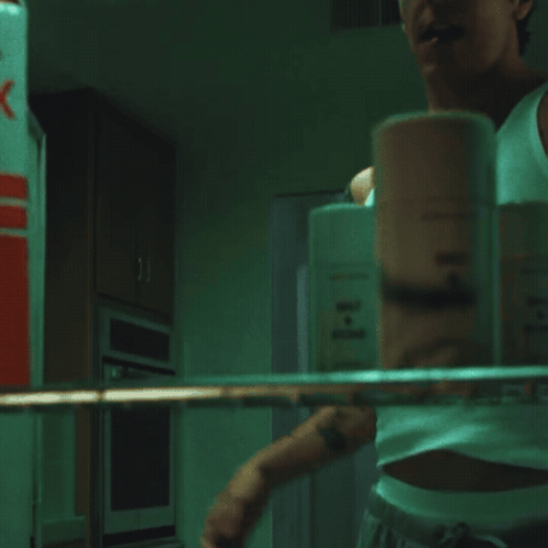 a man is drinking milk from a carton that says s on it