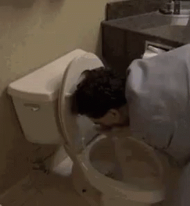 A Man Is Drinking Out Of A Toilet . GIF