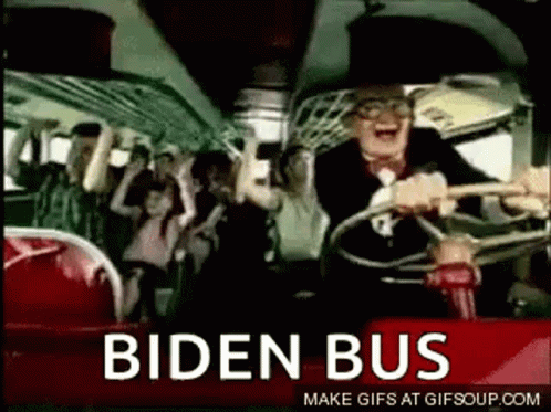 A Man Is Driving A Bus With A Crowd Of People On It And The Words Biden Bus On The Side . GIF