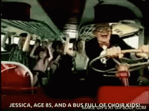 A Man Is Driving A Bus With A Group Of People . GIF