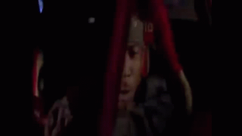 A Man Is Driving A Car And Talking On A Cell Phone While Holding A Gun . GIF