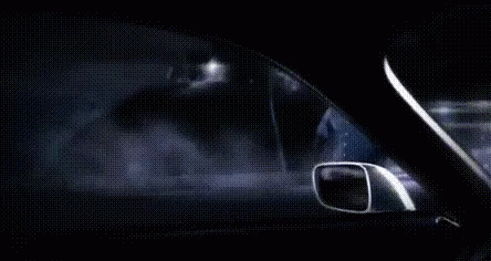 A Man Is Driving A Car At Night In The Fog . GIF