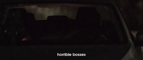 A Man Is Driving A Car At Night With Horrible Bosses Written On The Bottom Of The Screen GIF