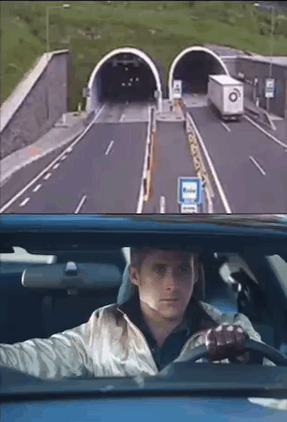 A Man Is Driving A Car Through A Tunnel And Looking Out The Window . GIF