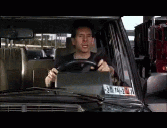 A Man Is Driving A Car With A License Plate That Says 20-22 GIF