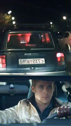 A Man Is Driving A Car With A License Plate That Says E98t2e75 GIF