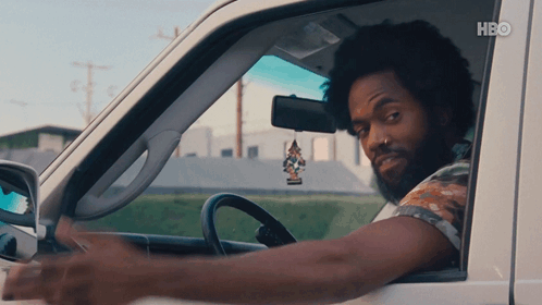 A Man Is Driving A Car With Hbo Written On The Bottom Right GIF
