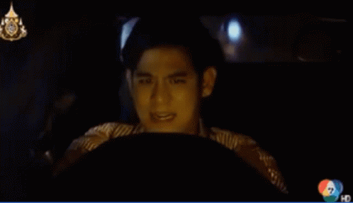 A Man Is Driving A Car With The Number 7 On The Bottom GIF