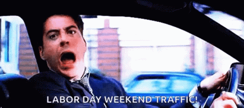 A Man Is Driving A Car With The Words Labor Day Weekend Traffic Written On The Screen GIF