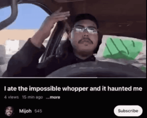 a man is driving a car with the words " late the impossible whopper and it haunted me " below him