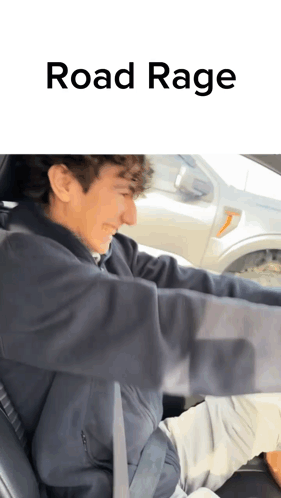 A Man Is Driving A Car With The Words Road Rage Written On The Bottom GIF