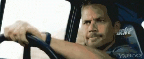 A Man Is Driving A Car With Yahoo Written On The Back Seat GIF