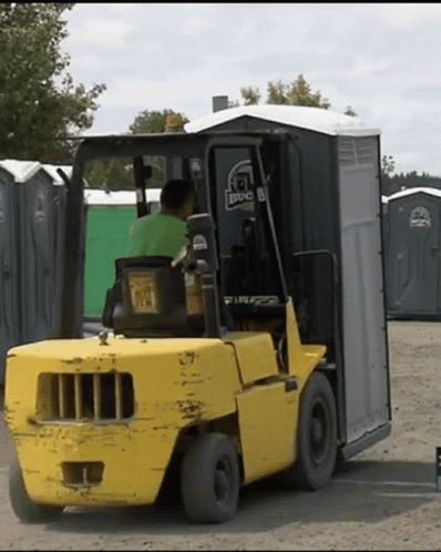 A Man Is Driving A Forklift With A Bbc Logo On The Back GIF