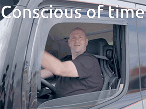 A Man Is Driving A Truck With The Words " Conscious Of Time " Written Above Him GIF