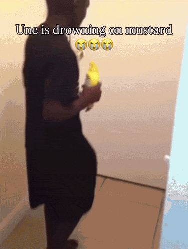 A Man Is Drowning On Mustard While Holding A Yellow Banana GIF