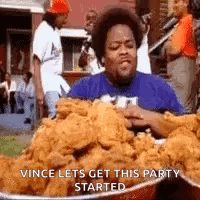 A Man Is Eating A Large Bowl Of Fried Chicken . GIF