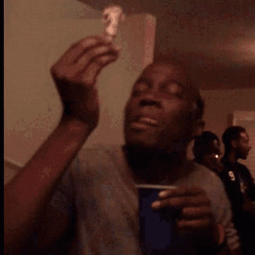 A Man Is Eating A Piece Of Cake With A Smile On His Face GIF