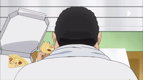 A Man Is Eating A Pizza With A Box Of Pizza In The Background GIF