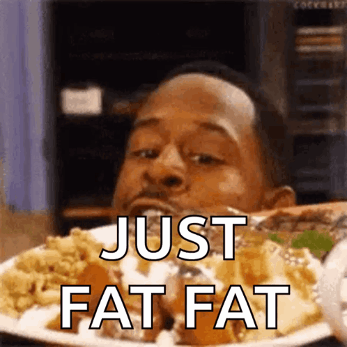 A Man Is Eating A Plate Of Food And The Words Just Fat Fat Are On The Plate GIF