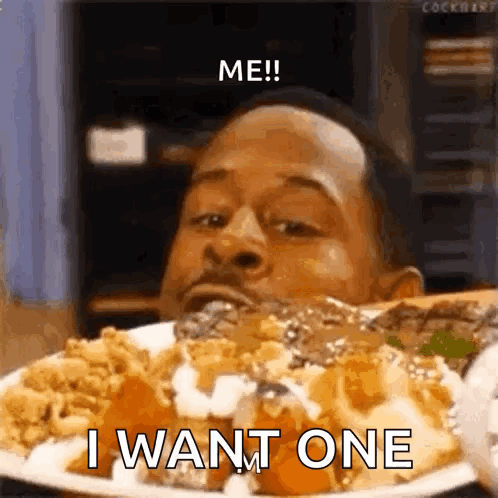 A Man Is Eating A Plate Of Food With The Words `` Me ! I Want One '' Written On It . GIF