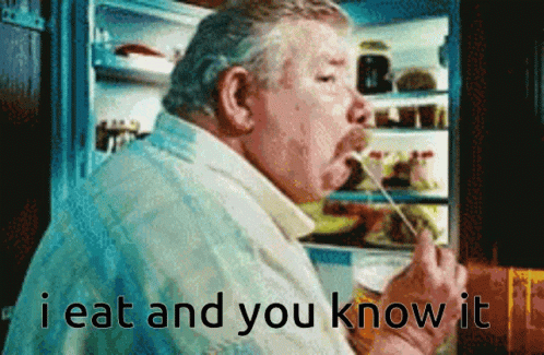 A Man Is Eating Something In Front Of A Refrigerator With The Words " I Eat And You Know It " GIF