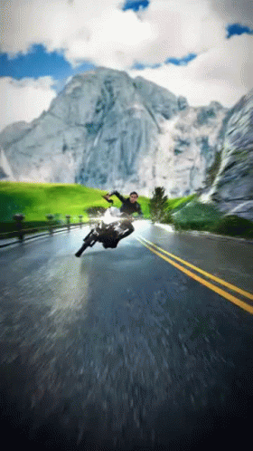 A Man Is Falling Off A Motorcycle On A Road GIF