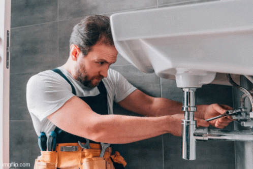 A Man Is Fixing A Sink With A Wrench And The Website Imgflip.com Is Below Him GIF