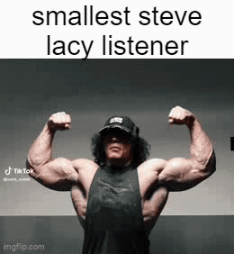 A Man Is Flexing His Muscles In A Gym . GIF