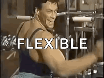 A Man Is Flexing His Muscles On A Machine In A Gym And Smiling . GIF
