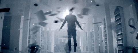 A Man Is Flying Through A Hallway With Papers Falling From The Ceiling GIF