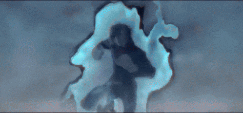 A Man Is Flying Through The Air With A Blue Light Coming Out Of His Hands GIF