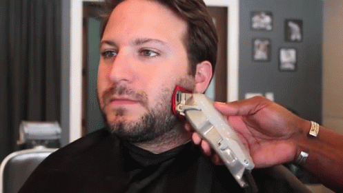 a man is getting his beard trimmed with a wahl brand clipper