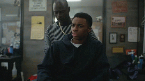 A Man Is Getting His Hair Cut By A Barber In Front Of A Sign That Says " No Smoking " GIF