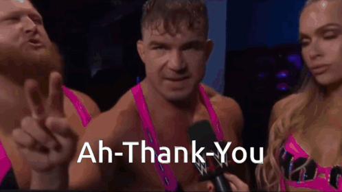 A Man Is Giving A Peace Sign While A Woman Holds A Microphone And Says " Ah-Thank-You " GIF