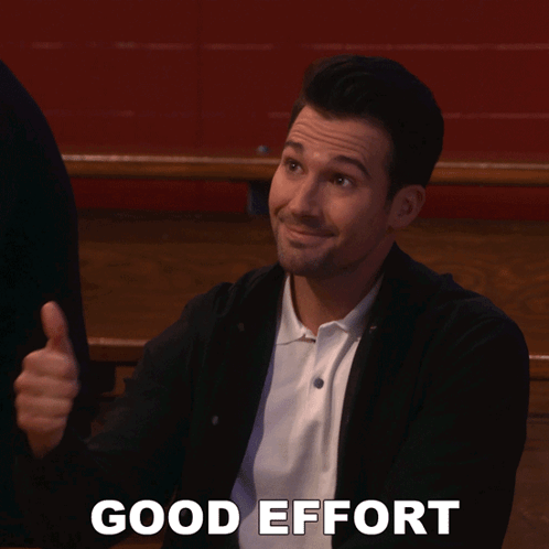 A Man Is Giving A Thumbs Up And The Words Good Effort Are Behind Him GIF