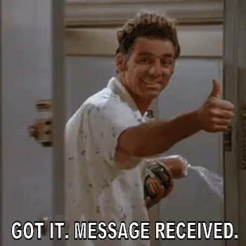 A Man Is Giving A Thumbs Up In A Bathroom While Holding A Hose . GIF