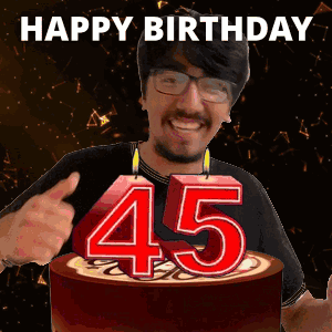 A Man Is Giving A Thumbs Up In Front Of A Cake With Candles That Say 45 GIF